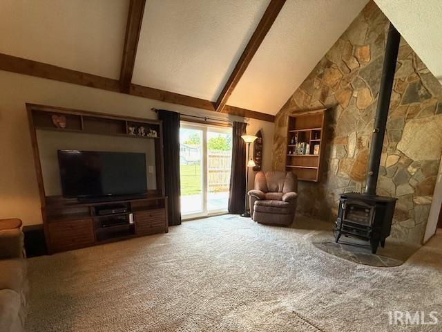 9910 Quachita Ct, Fort Wayne, IN 46804 - living area featuring carpet flooring, beamed ceiling, a wood stove, high vaulted ceiling, and a textured ceiling
