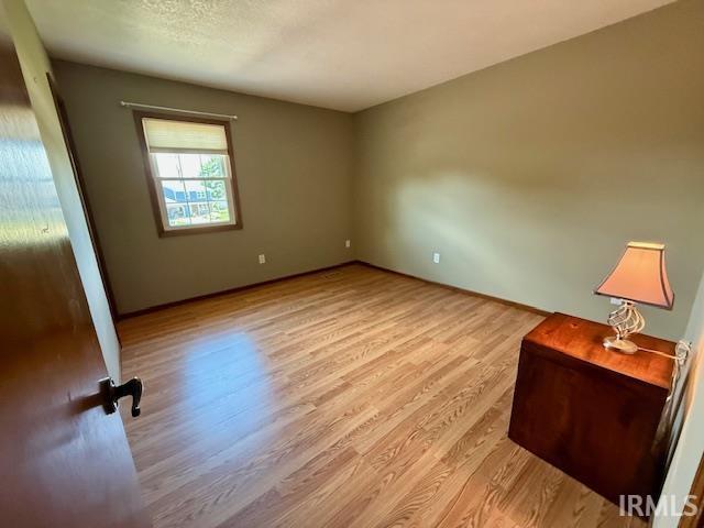9910 Quachita Ct, Fort Wayne, IN 46804 - empty room with wood finished floors and baseboards