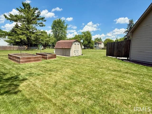 9910 Quachita Ct, Fort Wayne, IN 46804 - view of yard with a garden and a storage unit