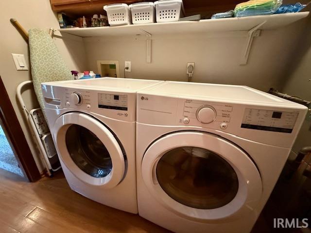 9910 Quachita Ct, Fort Wayne, IN 46804 - washroom featuring washer and clothes dryer and wood finished floors