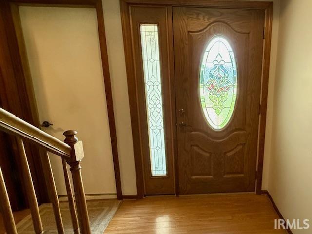 9910 Quachita Ct, Fort Wayne, IN 46804 - foyer featuring light wood finished floors and stairs