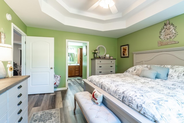 1709 Krebs Ct, Angola, IN 46703 - bedroom featuring a raised ceiling, dark wood-style flooring, ensuite bathroom, and a ceiling fan
