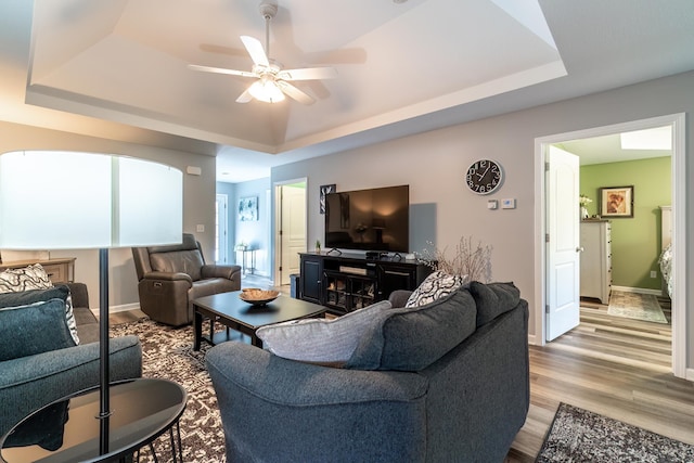 1709 Krebs Ct, Angola, IN 46703 - living room with a raised ceiling, a ceiling fan, and light wood-style flooring