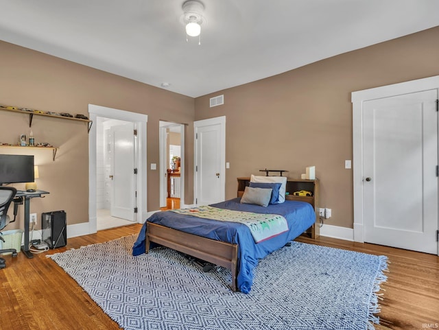 1337 W Wayne St, Fort Wayne, IN 46802 - bedroom with wood finished floors and connected bathroom