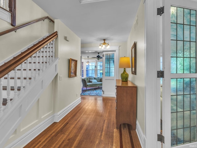 1337 W Wayne St, Fort Wayne, IN 46802 - hall with wood finished floors, stairs, and a chandelier