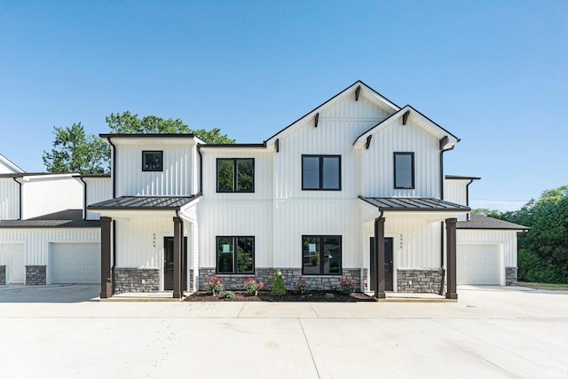 5960/62/64/66 N Clinton St, Fort Wayne, IN 46825 - modern farmhouse style home featuring a standing seam roof, concrete driveway, and covered porch