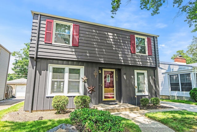 1150 Lexington Ave, Fort Wayne, IN 46807 - view of front facade featuring board and batten siding, an outdoor structure, and a garage