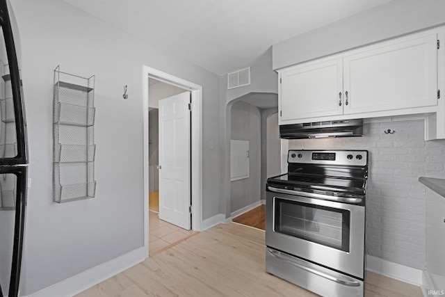 1150 Lexington Ave, Fort Wayne, IN 46807 - kitchen featuring appliances with stainless steel finishes, under cabinet range hood, white cabinetry, arched walkways, and light wood-type flooring