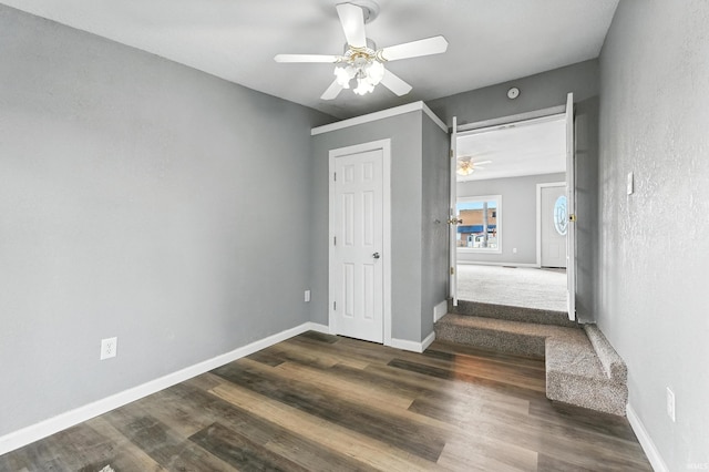 615 E Main St, Butler, IN 46721 - unfurnished bedroom featuring dark wood-type flooring and a ceiling fan