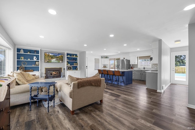 1827 N State Road 257, Otwell, IN 47564 - living area featuring dark wood-style flooring, a fireplace, and recessed lighting
