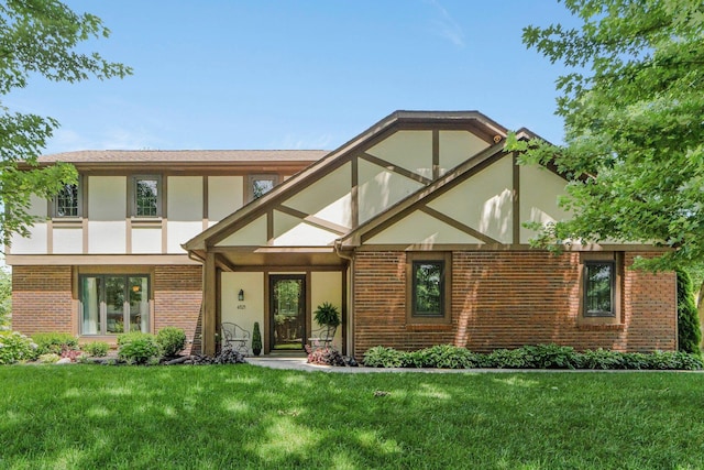 6521 Woodthrush Dr, Fort Wayne, IN 46835 - tudor home with stucco siding, brick siding, and a front yard