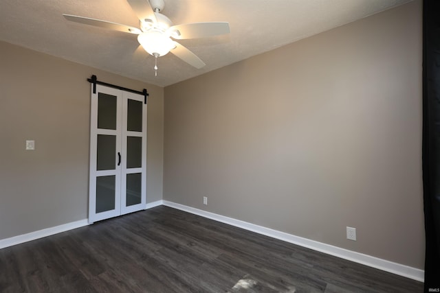 2114 S Branson St, Marion, IN 46953 - empty room featuring dark wood-style flooring, ceiling fan, and a barn door