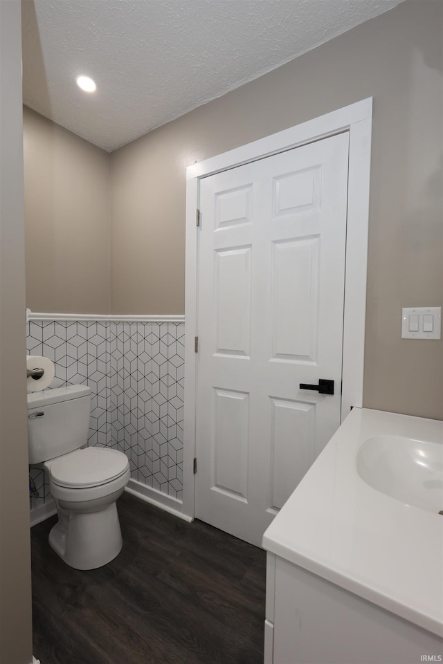 2114 S Branson St, Marion, IN 46953 - bathroom featuring tile walls, wood finished floors, wainscoting, vanity, and a textured ceiling