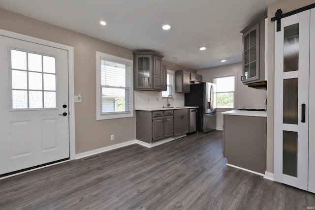 2114 S Branson St, Marion, IN 46953 - kitchen featuring appliances with stainless steel finishes, gray cabinets, light countertops, glass insert cabinets, and dark wood-style flooring