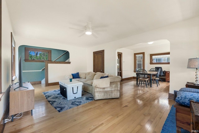 2001 N Anthony Blvd, Fort Wayne, IN 46805 - living area featuring arched walkways, a ceiling fan, light wood-style flooring, and stairway