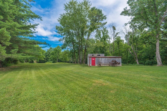 8099 S Breeden Rd, Bloomington, IN 47403 - view of green lawn featuring an outdoor structure and a view of trees