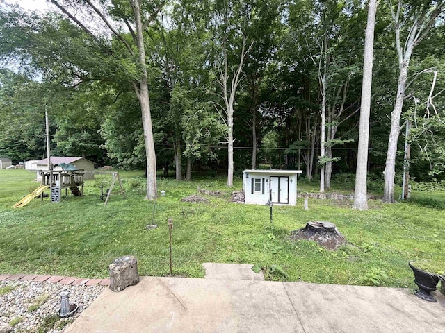 1015 Timbercrest Dr, Logansport, IN 46947 - view of green lawn featuring a playground and an outbuilding