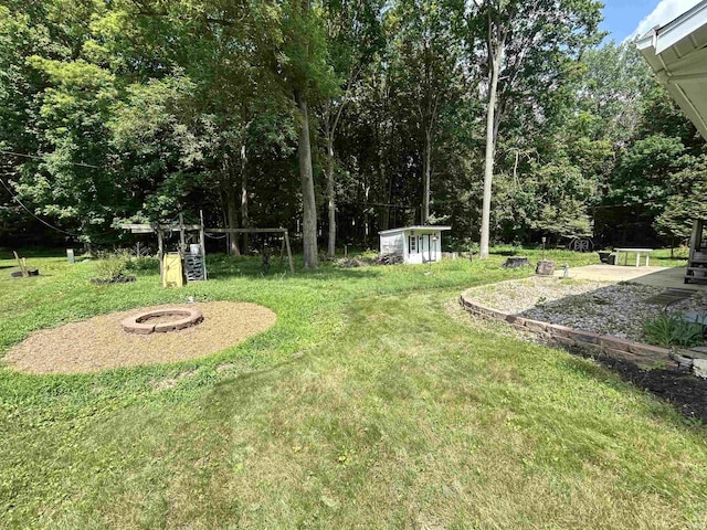 1015 Timbercrest Dr, Logansport, IN 46947 - view of grassy yard with a fire pit and an outbuilding