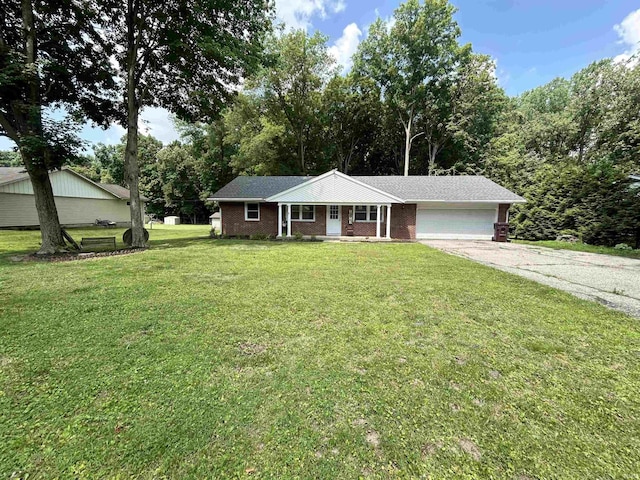 1015 Timbercrest Dr, Logansport, IN 46947 - single story home featuring a garage, asphalt driveway, a porch, brick siding, and a front yard