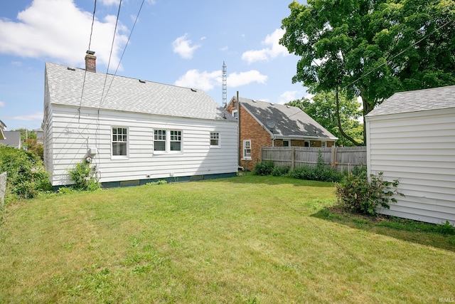 2606 Prast Blvd, South Bend, IN 46628 - rear view of house featuring a chimney and roof with shingles