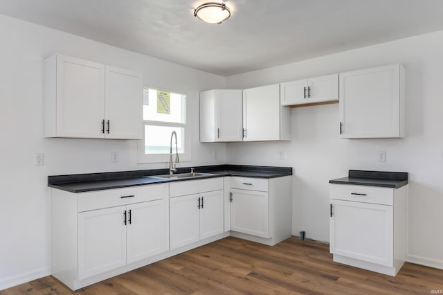 384 Chatham Ct, Union City, IN 47390 - kitchen featuring dark countertops, white cabinets, and wood finished floors