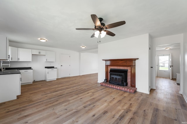 384 Chatham Ct, Union City, IN 47390 - unfurnished living room with ceiling fan, light wood-style floors, and a brick fireplace