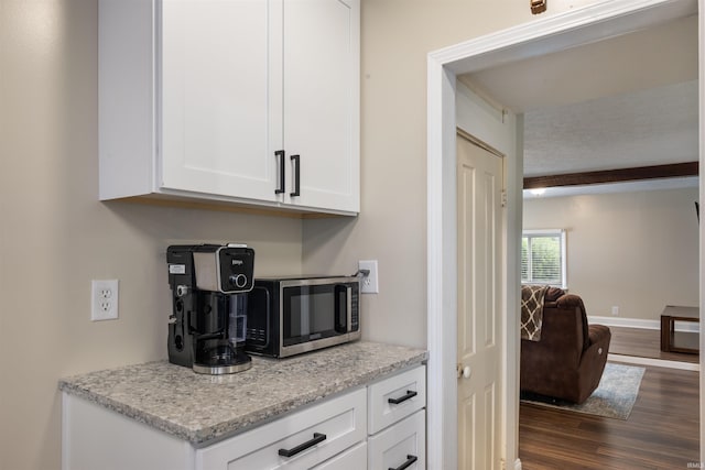 9462 W 1200 S 35, Marion, IN 46952 - kitchen with stainless steel microwave, dark wood-style floors, white cabinetry, and light stone countertops