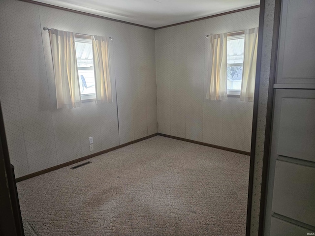 207 E Columbia St, Logansport, IN 46947 - carpeted empty room featuring crown molding