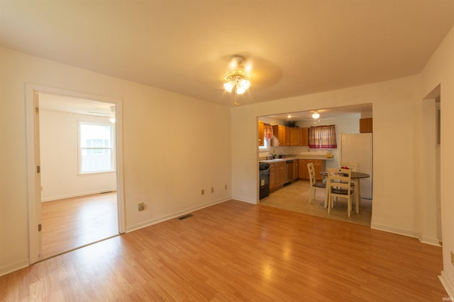 301 N Ohio Ave, Chandler, IN 47610 - unfurnished living room with a ceiling fan and light wood-type flooring