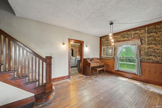 3192 N 150 W, Kokomo, IN 46901 - dining area featuring wood-type flooring, a textured ceiling, wainscoting, and stairs