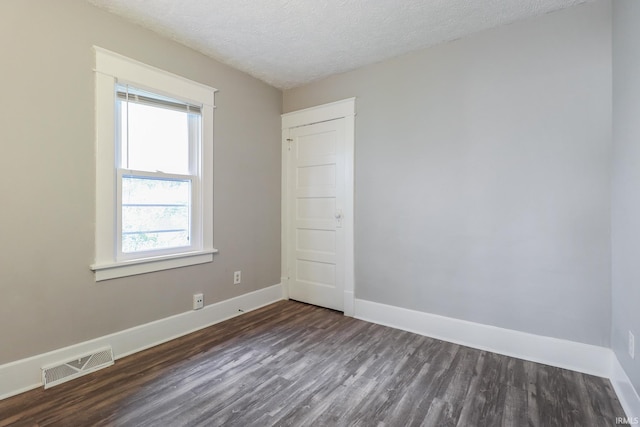 1110 Chalfant St, South Bend, IN 46617 - unfurnished room featuring dark wood finished floors, healthy amount of natural light, and a textured ceiling