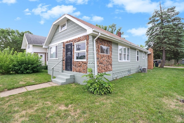 1110 Chalfant St, South Bend, IN 46617 - bungalow with a chimney, a front yard, stone siding, and entry steps