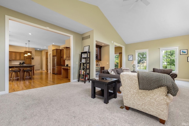 61705 Greentree Dr, South Bend, IN 46614 - living area with light colored carpet, ceiling fan, recessed lighting, and high vaulted ceiling