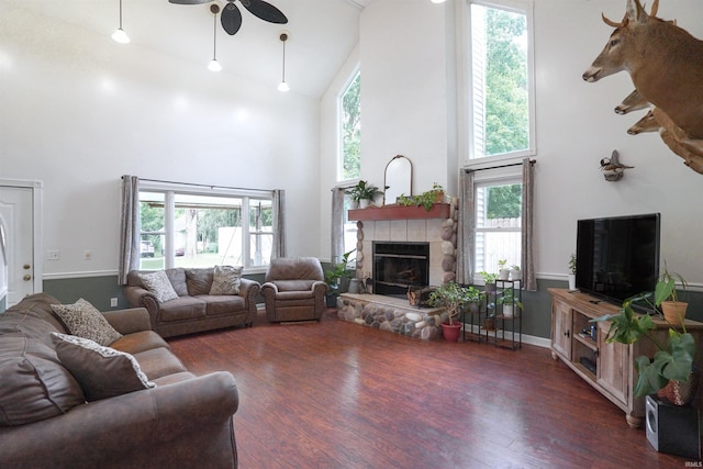8558 E John Emery Rd, New Carlisle, IN 46552 - living area with high vaulted ceiling, a fireplace, a ceiling fan, and wood finished floors