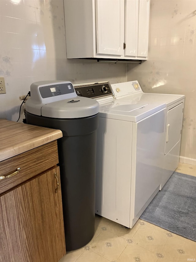 402 Charles St, Union City, IN 47390 - laundry area featuring washing machine and clothes dryer, cabinet space, and light tile patterned floors