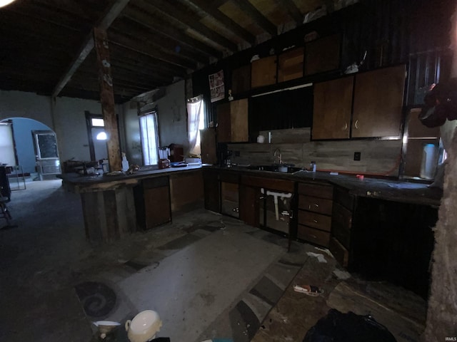 324 Tanguy St, Logansport, IN 46947 - kitchen featuring arched walkways, open floor plan, a peninsula, and unfinished concrete floors