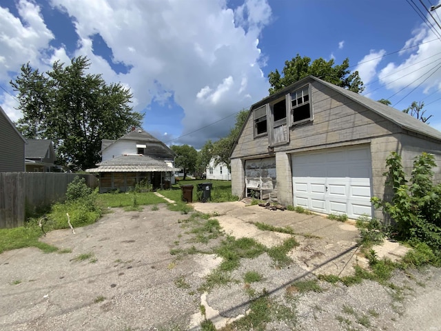 324 Tanguy St, Logansport, IN 46947 - view of home's exterior featuring a garage, an outdoor structure, and concrete block siding