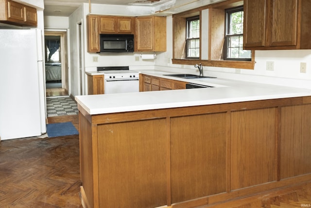 1121 W Grant St, Ellettsville, IN 47429 - kitchen featuring white appliances, light countertops, a peninsula, and brown cabinets