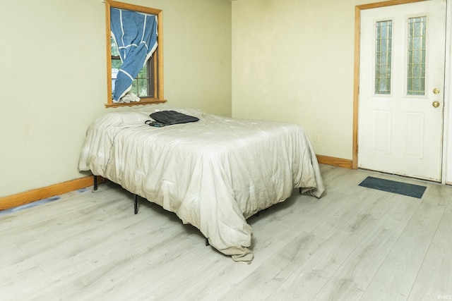 1121 W Grant St, Ellettsville, IN 47429 - bedroom featuring wood finished floors and multiple windows