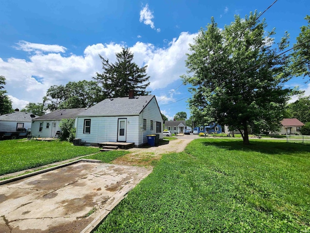 2206 S Hackley St, Muncie, IN 47302 - rear view of house with a yard and a chimney