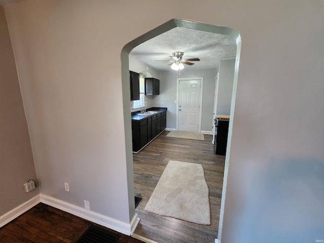 2206 S Hackley St, Muncie, IN 47302 - hall with dark wood-style flooring, arched walkways, and a textured ceiling