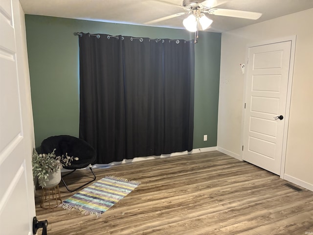 7775 N Hudson Ln, Solsberry, IN 47459 - spare room with a ceiling fan and wood finished floors