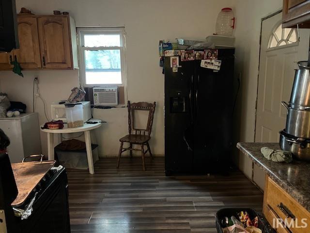 1919 Fletcher St, Anderson, IN 46016 - kitchen with black fridge with ice dispenser, cooling unit, dark wood-style flooring, and dark countertops