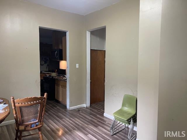 1919 Fletcher St, Anderson, IN 46016 - living area featuring dark wood-type flooring and baseboards