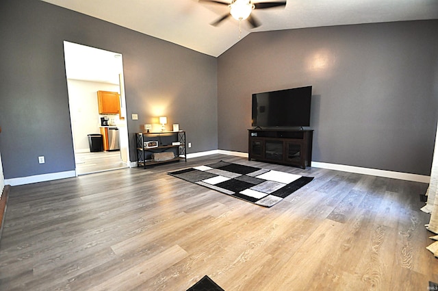21573 Kern Rd, South Bend, IN 46614 - living room featuring a ceiling fan, vaulted ceiling, and wood finished floors