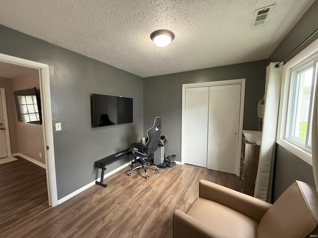 308 E Fourth St, North Webster, IN 46555 - home office featuring wood finished floors and a textured ceiling