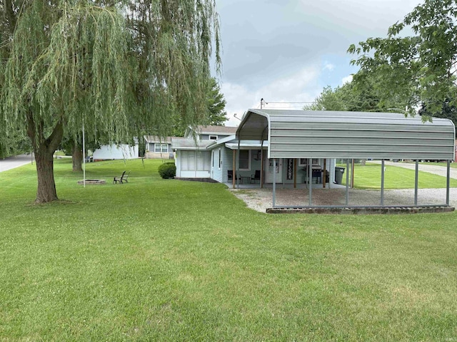 308 E Fourth St, North Webster, IN 46555 - view of grassy yard with a detached carport