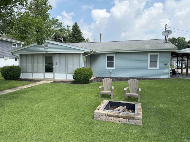 308 E Fourth St, North Webster, IN 46555 - rear view of house with an outdoor fire pit, a yard, and a patio