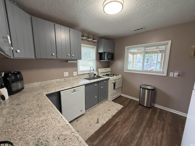 308 E Fourth St, North Webster, IN 46555 - kitchen with white appliances, gray cabinets, dark wood-style floors, and a textured ceiling