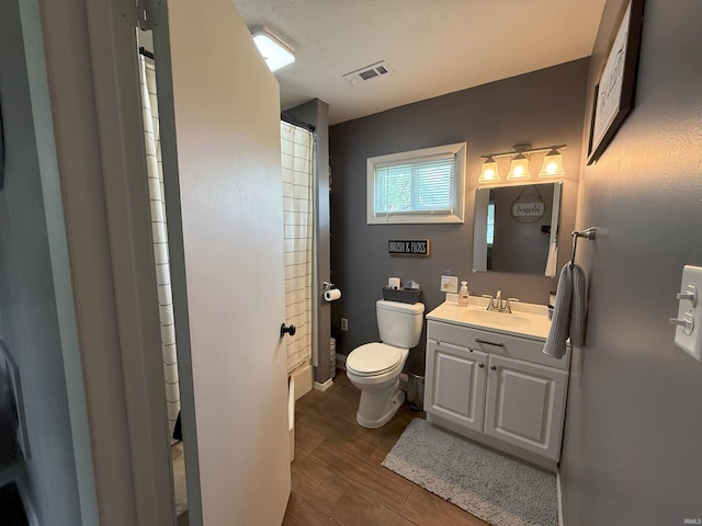 308 E Fourth St, North Webster, IN 46555 - full bathroom featuring vanity, a shower with shower curtain, and wood finished floors